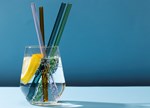 Transparent Glass With Fizzy Water And Colored Glass Straws